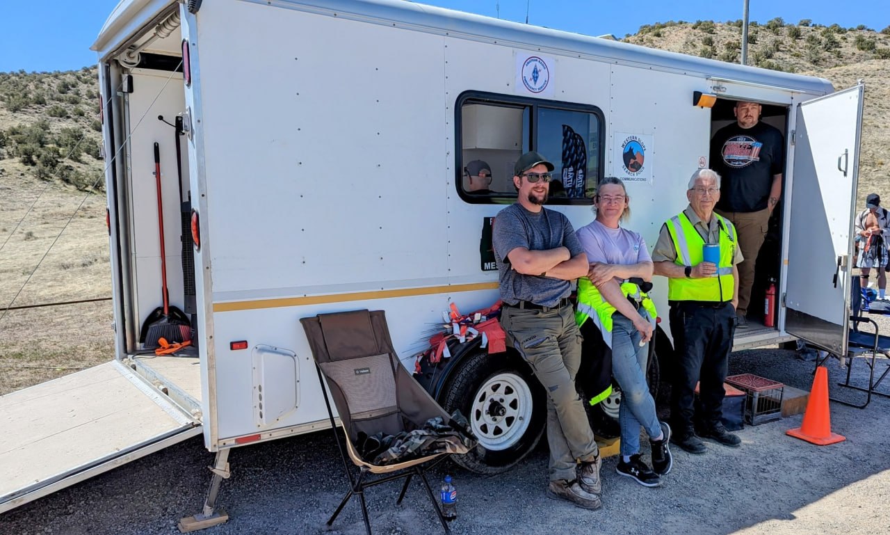 WestCO operators standing beside a communications trailer in sunny western Colorado