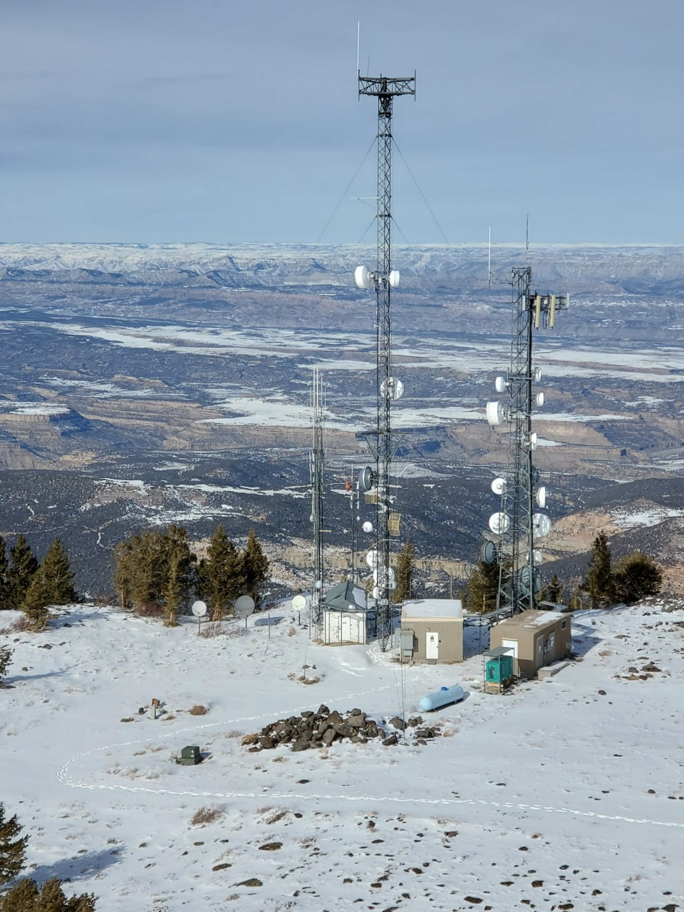Mountain repeater site overlooking snowy western Colorado terrain